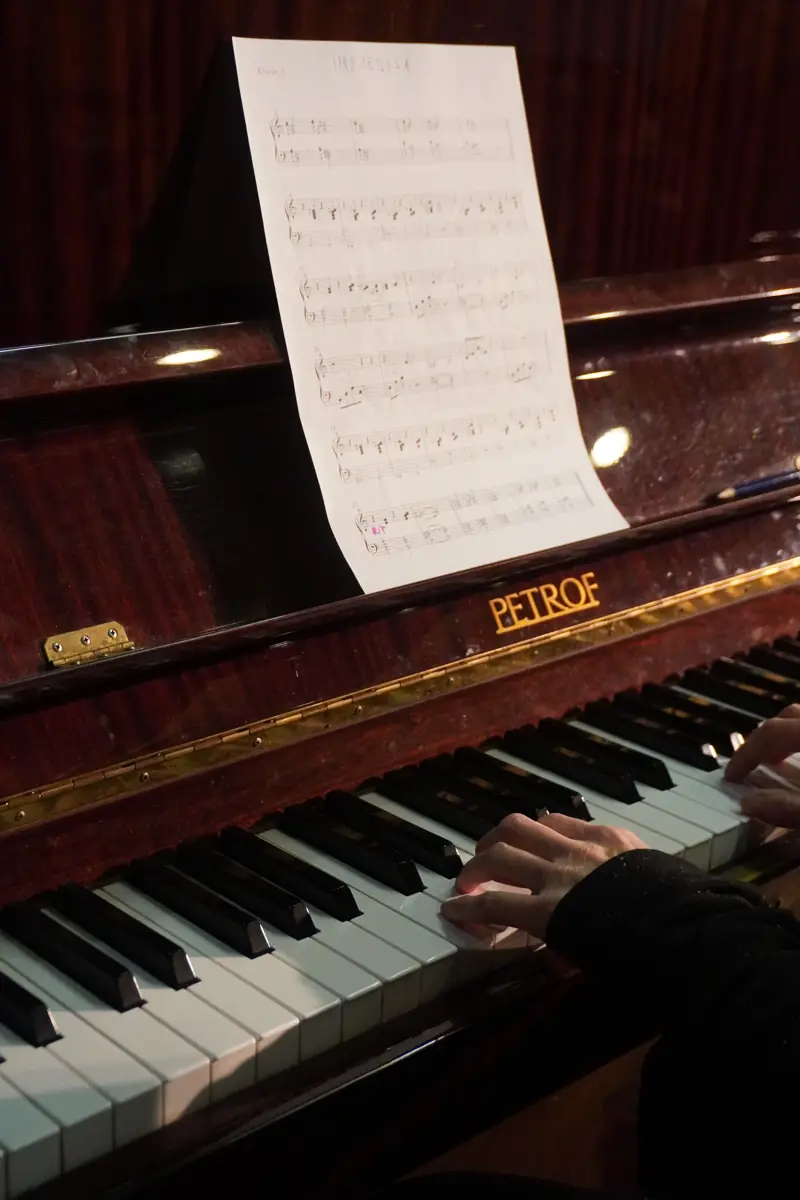 A piano and an open score, ready to play