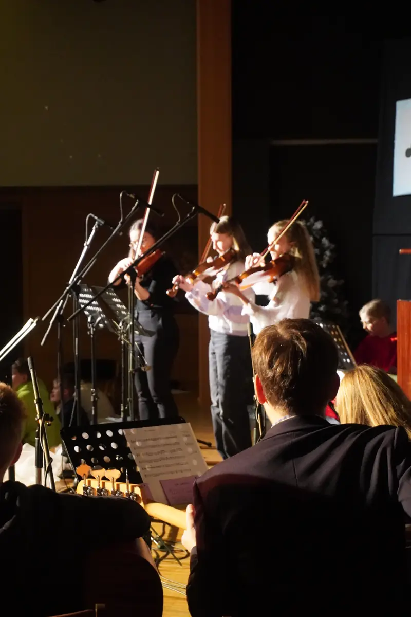 Violinists and a pianist playing together